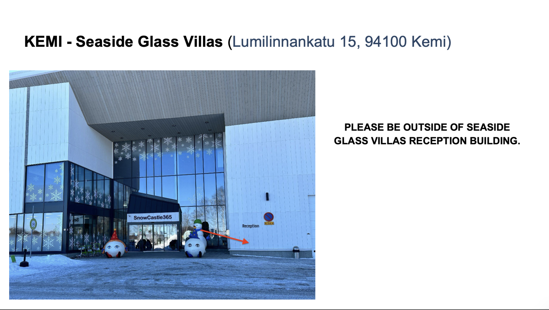 Entrance of Seaside Glass Villas reception building decorated with snowflake decals on glass and two large snowman figures beside the doors.